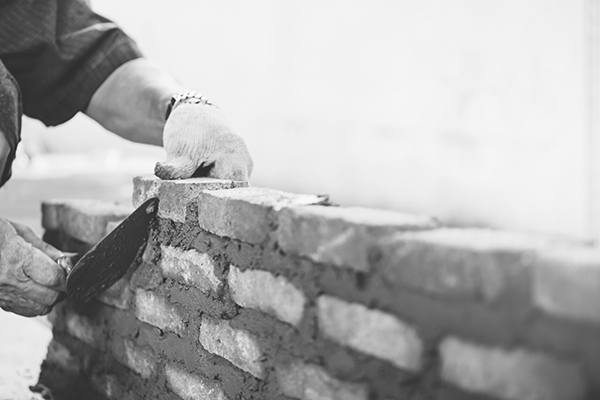 brick layer building brick wall
